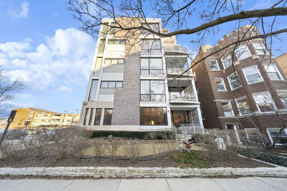 Front view of a multi-story residential building with a modern design.