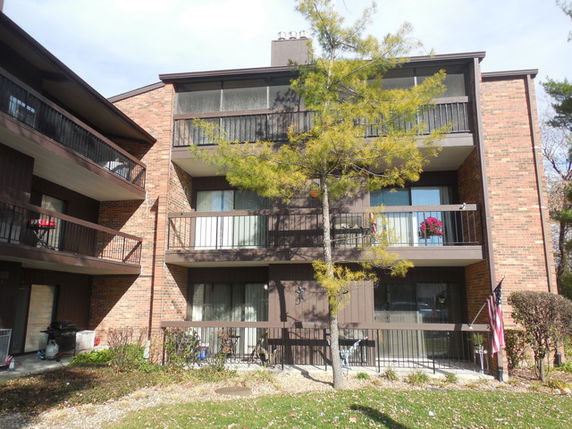 Front view of a multi-story building with balconies.