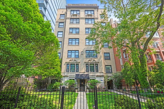 Front view of a multi-story residential building with a brick exterior.