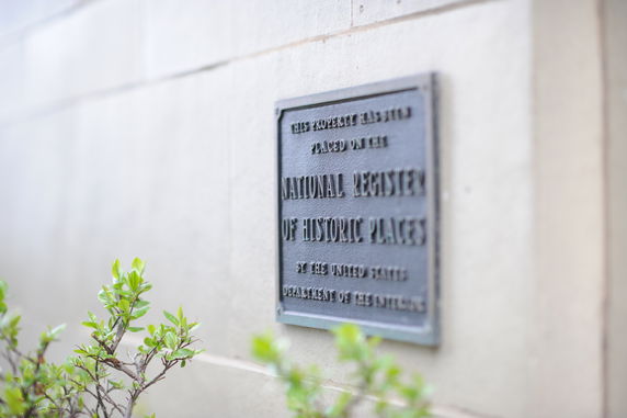 Plaque on the wall of a historic building.