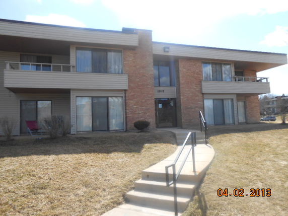 Front view of a two-story apartment building with balconies.