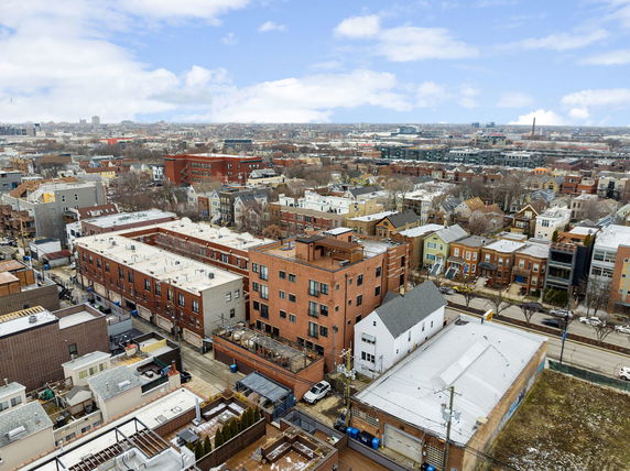 Wide-angle view of an urban neighborhood with various residential buildings and structures.