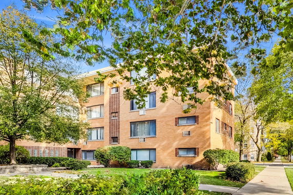 Front view of a multi-story brick apartment building.
