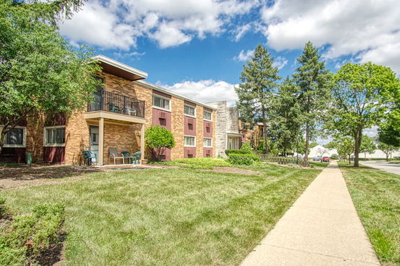 Front view of a multi-story residential building with balconies.
