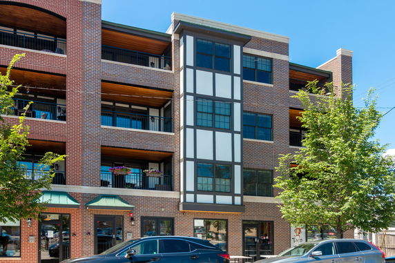 Front view of a multi-story brick building with balconies.