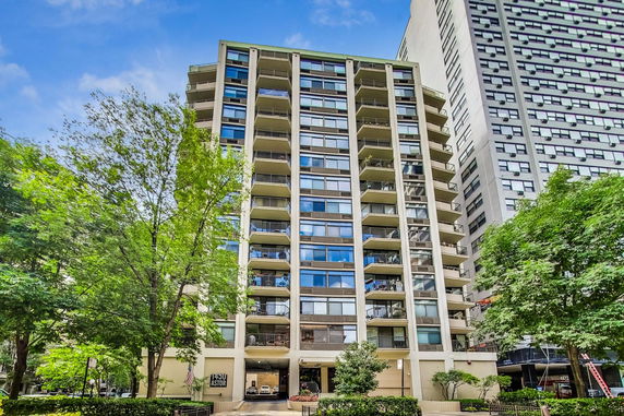 Front view of a multi-story residential building with balconies.
