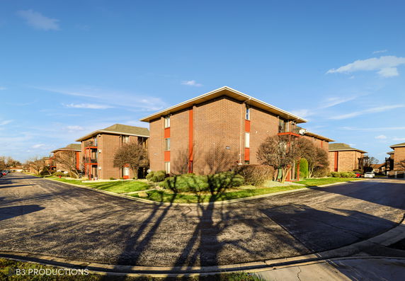 Front view of multiple-story brick apartment buildings.