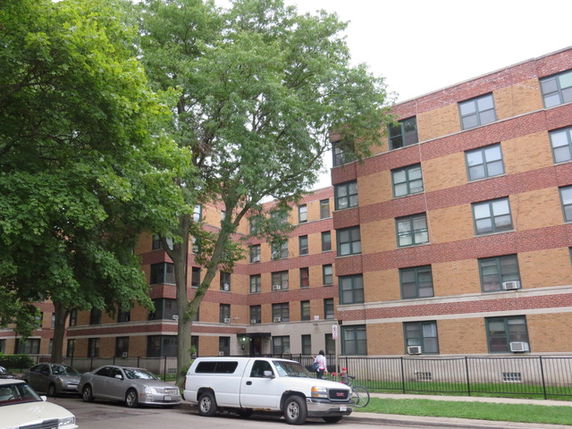 Front view of a multi-story brick apartment building.