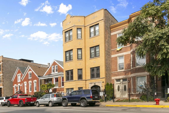 Front view of a multi-story brick apartment building.