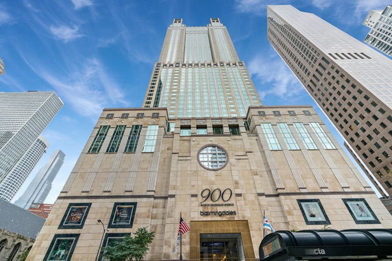 Front view of a tall commercial building with multiple stories and a prominent facade.