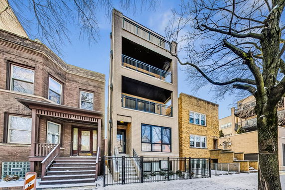 Front view of a multi-story residential building with balconies.