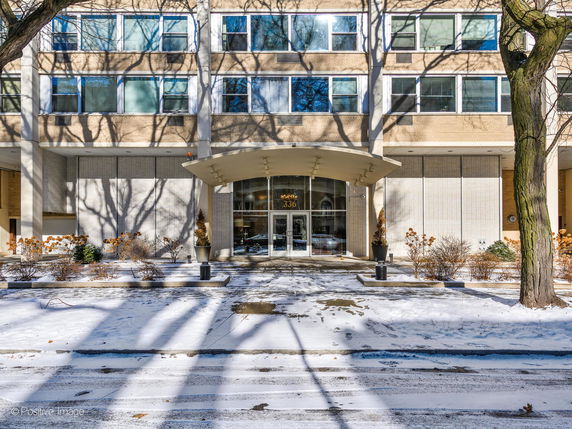 Front view of a multi-story building with numerous windows and a central entrance.