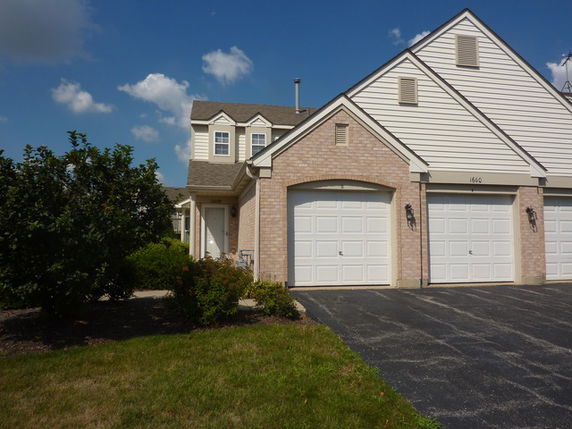 Front view of a two-story house with a double garage.