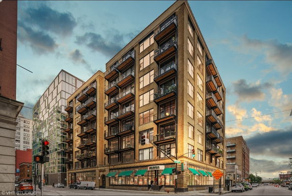 Front view of a multi-story apartment building with balconies.