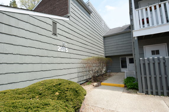 Front view of a building with a gray exterior and the number 2075.