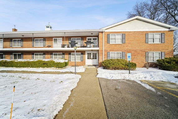 Front view of a two-story brick apartment building.