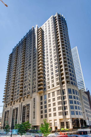 Front view of a high-rise residential building with balconies.