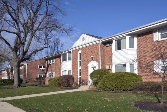 Front view of a two-story brick apartment building.