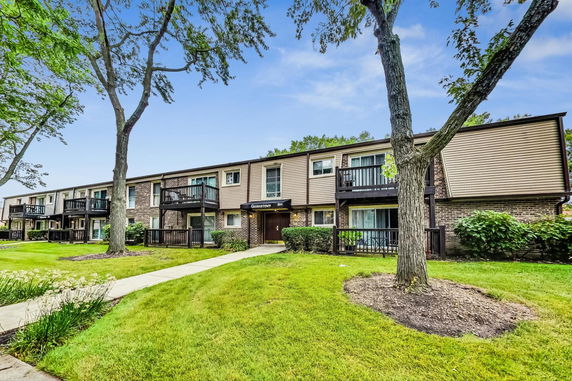 Front view of a two-story apartment building with balconies.
