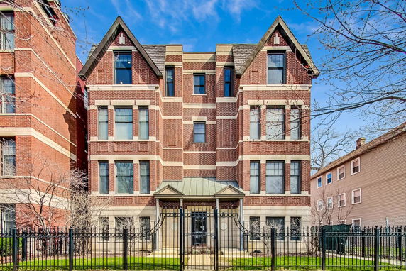 Front view of a multi-story brick building with decorative gables.