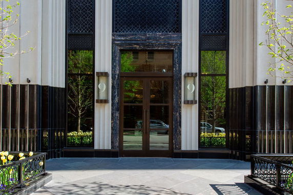 Front view of a building entrance with large glass doors and windows.