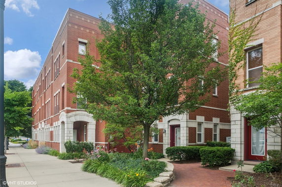 Front view of a multi-story brick building with white accents.