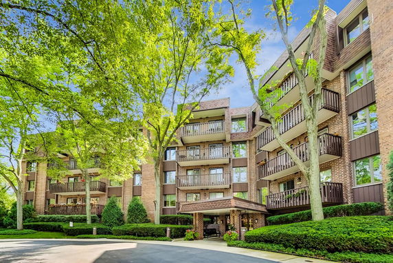 Front view of a multi-story apartment building with balconies.