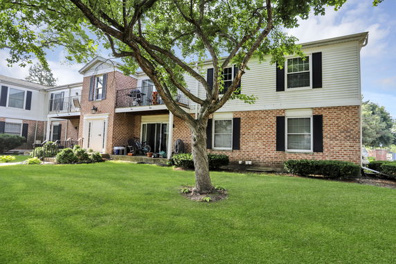 Front view of a two-story brick and siding building with balconies.