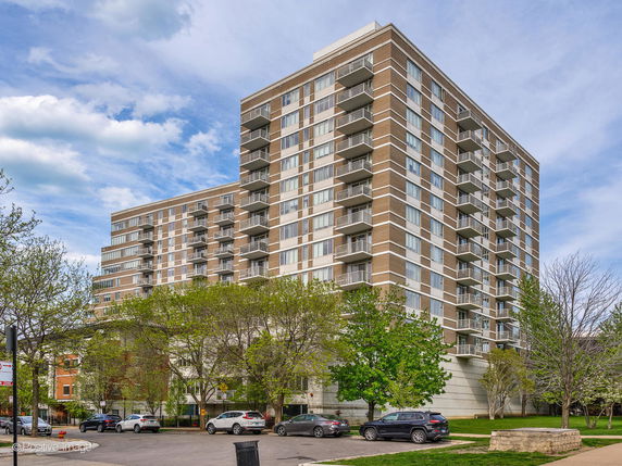 Front view of a multi-story residential building with balconies.