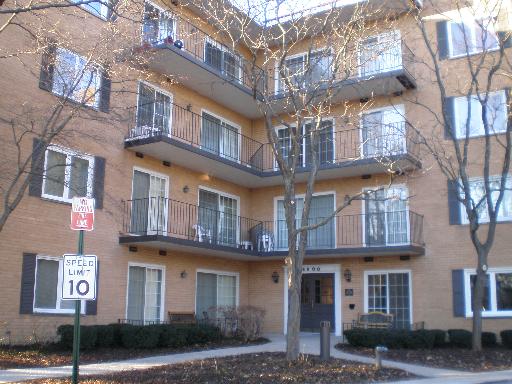 Front view of a multi-story apartment building with balconies.