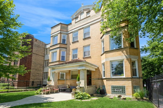 Front view of a three-story brick building with a covered entrance.