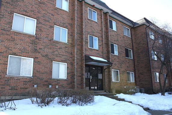 Front view of a multi-story brick apartment building