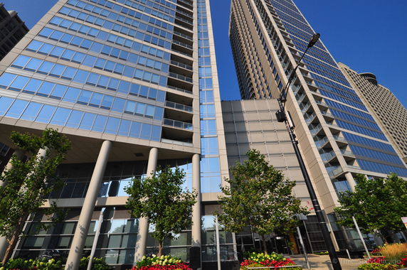 Front view of two tall glass skyscrapers with multiple floors.
