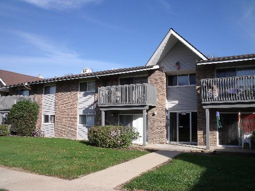 Front view of a two-story apartment building with balconies.