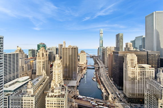 Panoramic view of a cityscape with river and skyscrapers.