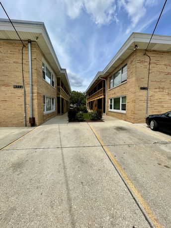 Front view of two-story brick buildings with symmetrical design.