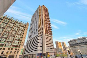 Front view of a tall high-rise building with balconies.