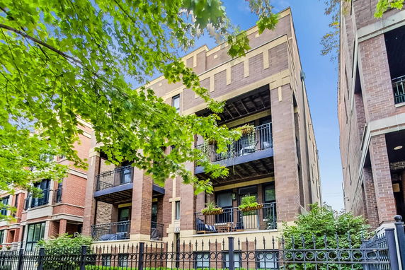 Front view of a multi-story residential building with balconies.