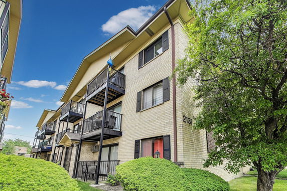 Front view of a multi-story building with balconies.