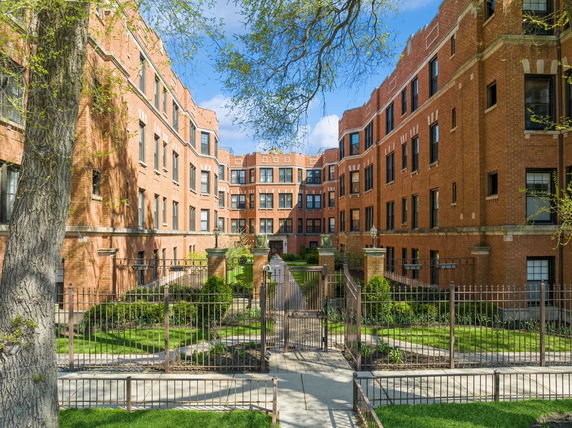 Front view of a multi-story brick apartment building.