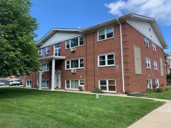 Front view of a two-story brick apartment building.