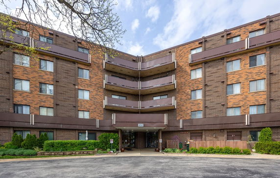 Front view of a multi-story brick building with balconies.