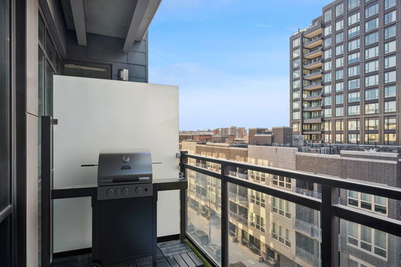 View from a balcony overlooking modern urban buildings.