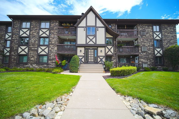 Front view of a multi-story building with balconies.