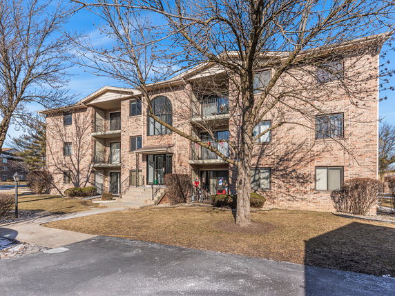 Front view of a three-story brick apartment building.