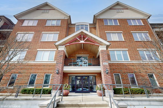 Front view of a multi-story brick building with a covered entrance.