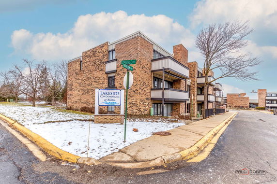 Front view of a multi-story brick condominium building.