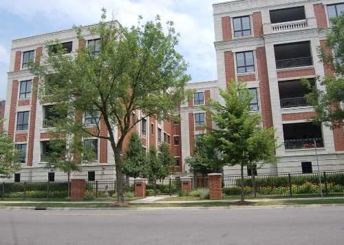 Front view of a multi-story brick apartment building.