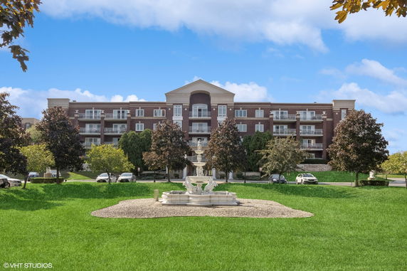 Front view of a multi-story brick building with balconies.