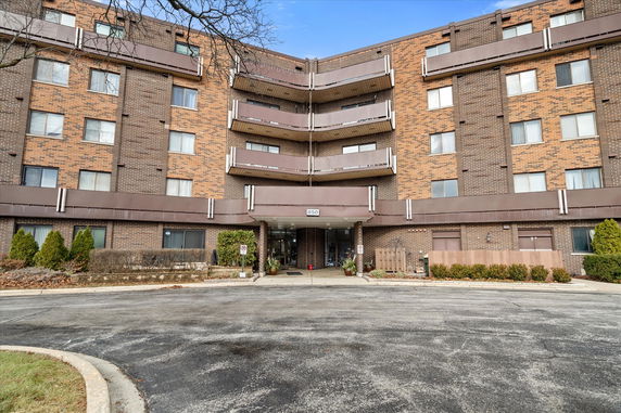 Front view of a multi-story brick apartment building.